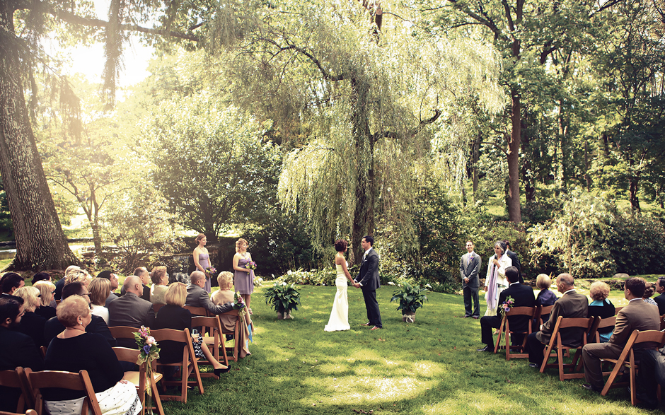 The bride and groom say their vows in front of friends and family on a warm September day at Appleford Estate in Villanova