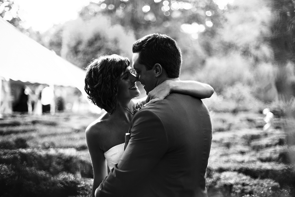 The bride and groom smile in the warm summer sunlight after their wedding at Appleford Estate in Villanova, PA, shown in black and white, photography by Peter Van Beever