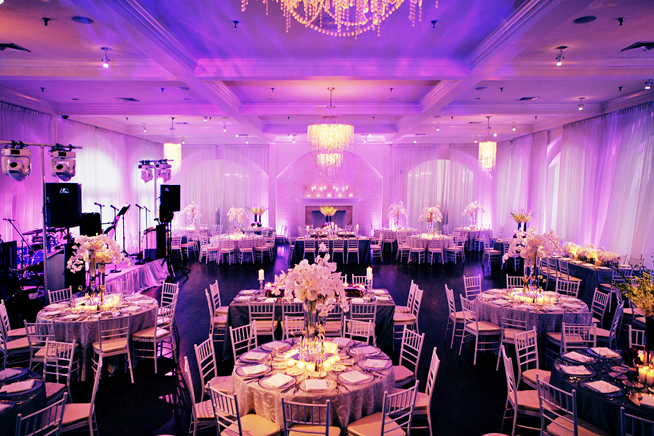 Purple lights elegantly compliment the crystal chandeliers and decor at the Belle Mer wedding reception in Newport Rhode Island, photographed by Peter Van Beever