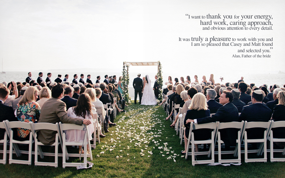 The bride and groom stand under the wedding chuppah at their Jewish wedding at the Belle Mer in Newport Rhode Island on a beautiful day surrounded by the beach and ocean, wedding photography by Peter Van Beever