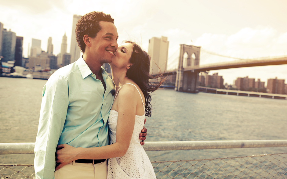 This couple walk along the river in New York City for their romantic engagement photos