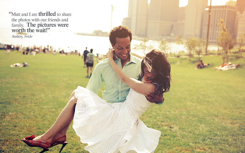 The groom holds and swings his bride around in the New York City sunshine for their engagement photos